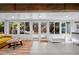 Inviting sunroom with tile flooring, a lounge area, and views of the backyard at 3417 W Alline Ave, Tampa, FL 33611