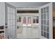Bright sunroom with white trim, exposed beams, tile floors, and glass doors to the backyard at 3417 W Alline Ave, Tampa, FL 33611