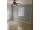 Cozy bedroom with neutral walls, tile floors, a ceiling fan, and natural light from window at 3502 E 33Rd Ave, Tampa, FL 33610