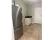 Kitchen features stainless steel refrigerator, tile floors and white storage cabinet at 3502 E 33Rd Ave, Tampa, FL 33610