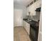 Well-organized kitchen with white cabinets, black appliances and countertops at 3502 E 33Rd Ave, Tampa, FL 33610