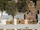 Birds-eye view of a charming blue home featuring a landscaped front yard and a garage on the left side at 3530 Umber Rd, Holiday, FL 34691