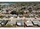 Aerial view of a neighborhood showing a charming blue home with waterfront access and nearby community features at 3530 Umber Rd, Holiday, FL 34691