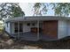 View of a covered back patio with a hot tub for outdoor relaxation and entertaining at 3530 Umber Rd, Holiday, FL 34691
