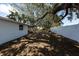 Large fenced backyard featuring mature trees offering shade and privacy for outdoor enjoyment at 3530 Umber Rd, Holiday, FL 34691