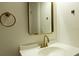 Bathroom vanity featuring a sleek mirror, modern faucet and a towel rack at 3530 Umber Rd, Holiday, FL 34691