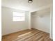Bedroom with wood-look flooring, closet, and natural light at 3530 Umber Rd, Holiday, FL 34691