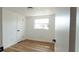 Cozy bedroom with wood flooring and a bright window at 3530 Umber Rd, Holiday, FL 34691