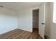 Bedroom featuring wood floors, bright window, and closet at 3530 Umber Rd, Holiday, FL 34691