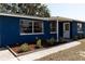 Charming single-story home featuring a blue exterior, well-maintained landscaping, and a welcoming front entrance at 3530 Umber Rd, Holiday, FL 34691