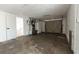 View of a spacious, empty garage with a utility closet for storage and access to the house at 3530 Umber Rd, Holiday, FL 34691