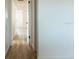 Hallway with white walls and wood floors leads to other rooms at 3530 Umber Rd, Holiday, FL 34691