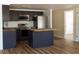 Modern kitchen featuring dark cabinets, stainless steel appliances, and wood countertops at 3530 Umber Rd, Holiday, FL 34691