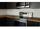 Modern stainless steel oven with dark cabinets and butcher block countertops at 3530 Umber Rd, Holiday, FL 34691