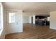Open floor plan featuring wood floors and fresh paint, leading to a modern kitchen in the background at 3530 Umber Rd, Holiday, FL 34691