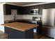 Close up of the kitchen featuring butcher block countertops and stainless appliances at 3530 Umber Rd, Holiday, FL 34691