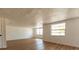 Large bright living room with new floors and freshly painted white walls at 3530 Umber Rd, Holiday, FL 34691