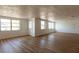 Spacious living room featuring wood floors, bright windows, and a modern design with fresh paint at 3530 Umber Rd, Holiday, FL 34691