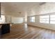 Spacious living room with light wood floors and bright natural light from windows at 3530 Umber Rd, Holiday, FL 34691