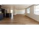 Open-concept living room with wood floors, natural light, and modern kitchen island at 3530 Umber Rd, Holiday, FL 34691