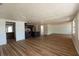 Spacious living room with new floors flowing into the modern kitchen with stainless steel appliances at 3530 Umber Rd, Holiday, FL 34691