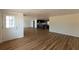 Open living space featuring wood floors and fresh paint, with a kitchen in the background at 3530 Umber Rd, Holiday, FL 34691