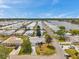 Aerial view of a waterfront community with a yellow home at 3716 Carioca Rd, Holiday, FL 34691