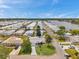 Aerial view of home with landscaping, long driveway, and proximity to the water at 3716 Carioca Rd, Holiday, FL 34691