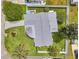 A charming single-story home featuring a spacious backyard, lush greenery, and a private, fenced-in yard at 3716 Carioca Rd, Holiday, FL 34691