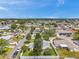 Aerial shot showcases neighborhood homes near a body of water, and green landscaping at 3716 Carioca Rd, Holiday, FL 34691