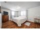 Comfortable bedroom with hardwood floors, natural light, and a cozy atmosphere at 3716 Carioca Rd, Holiday, FL 34691