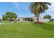 Well-maintained lawn, mature trees, and tidy landscaping enhancing the curb appeal of this charming home at 3716 Carioca Rd, Holiday, FL 34691