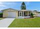 Charming home features a garage, screened lanai, and well-maintained lawn and landscaping at 3716 Carioca Rd, Holiday, FL 34691