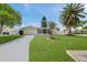 Charming home with a manicured lawn, screened porch, and attached garage at 3716 Carioca Rd, Holiday, FL 34691