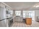A bright kitchen includes stainless appliances, neutral cabinets, and an eat-in counter at 3716 Carioca Rd, Holiday, FL 34691