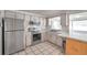 Bright kitchen features stainless steel appliances and tile flooring at 3716 Carioca Rd, Holiday, FL 34691