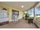Close-up of the cozy lanai featuring comfortable rocking chair and views of the front yard at 3716 Carioca Rd, Holiday, FL 34691