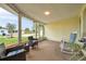 Spacious lanai featuring comfortable seating and views of the manicured lawn and neighborhood at 3716 Carioca Rd, Holiday, FL 34691