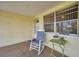Relaxing lanai with a rocking chair and small table, perfect for enjoying a morning coffee at 3716 Carioca Rd, Holiday, FL 34691