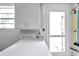 Well-lit laundry area features a washing machine, overhead cabinets, and a convenient folding space at 3716 Carioca Rd, Holiday, FL 34691