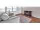 Comfortable living room with wood floors, gray couch, electric fireplace, and natural light at 3716 Carioca Rd, Holiday, FL 34691