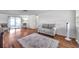 Bright living room featuring hardwood floors, a modern sofa and chairs, and sliding doors to the porch at 3716 Carioca Rd, Holiday, FL 34691