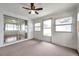 Sunroom featuring carpet floors, a ceiling fan, sliding glass doors, and a door to outside at 3716 Carioca Rd, Holiday, FL 34691