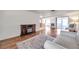 Spacious living room with wood floors, fireplace, with an open layout, and natural light at 3716 Carioca Rd, Holiday, FL 34691