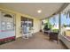 Cozy screened-in porch with comfortable seating, offering a relaxing outdoor living space with a view of the front yard at 3716 Carioca Rd, Holiday, FL 34691
