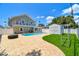 Spacious backyard with a pristine swimming pool, white fencing, storage shed, and well-maintained landscaping at 3801 Huntington Ne St, St Petersburg, FL 33703