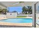 Relaxing backyard featuring a sparkling swimming pool, brick-paved deck, and tranquil outdoor setting at 3801 Huntington Ne St, St Petersburg, FL 33703