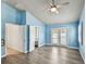 Bright bedroom with stylish gray wood floors, ensuite bathroom and walk-in closet, and access to patio at 3801 Huntington Ne St, St Petersburg, FL 33703