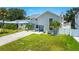 Beautifully landscaped home with a long driveway, lush green lawn, and modern architectural features at 3801 Huntington Ne St, St Petersburg, FL 33703