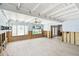 Spacious living room featuring tile floors, large windows overlooking the pool, and an open design with wood beam ceilings at 3801 Huntington Ne St, St Petersburg, FL 33703